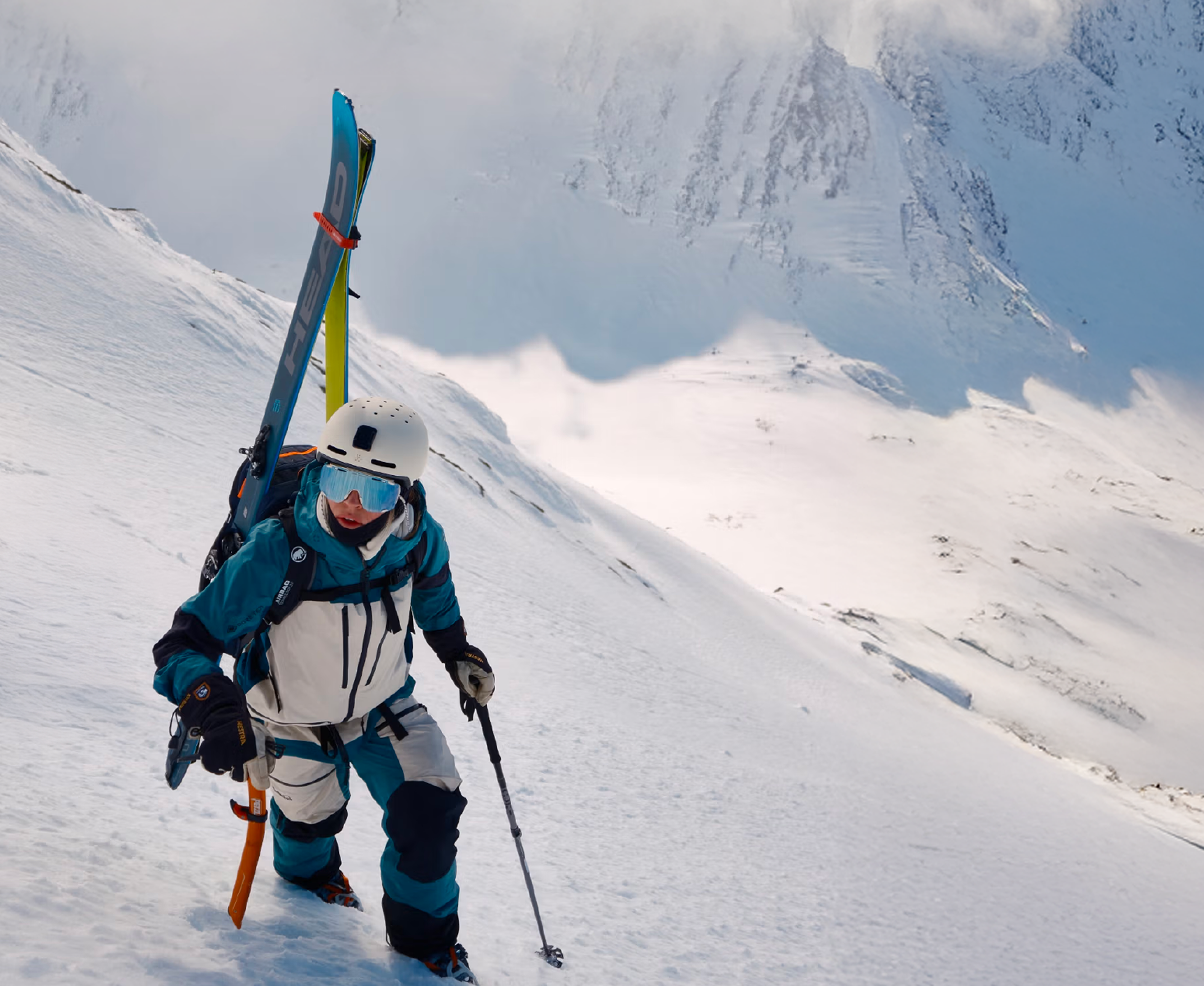 Ski mountaineer climbing a snowy slope